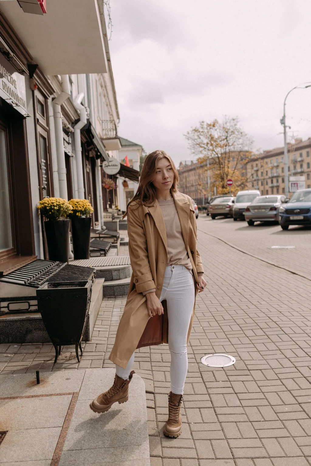 A woman walking down a city street on a flat afternoon. As you scroll, the same photo is remastered as Natural, Golden Hour, Backlit, Dusk and Teal Night.