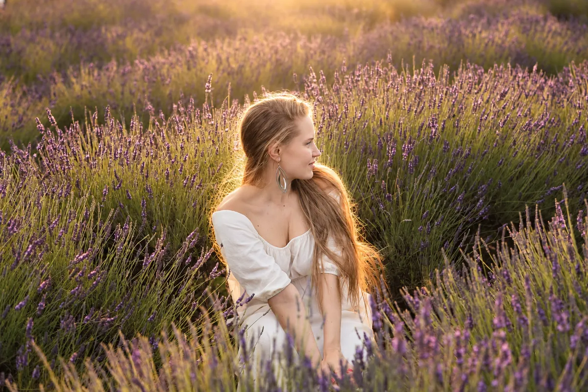 A woman in a lavender field in the evening sun
